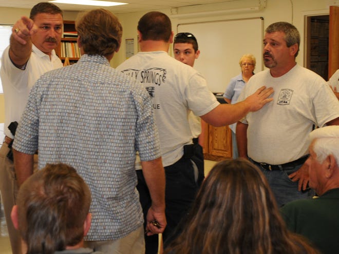 Holly Springs fire commissioners had a special called meeting at 2:45 p.m. Friday, where they fired Fire Chief Lee Jeffcoat. Supporters of Jeffcoat left the meeting in protest before his firing due to the timing of the meeting and the speakers chosen to talk. Here, Spartanburg County Sheriff Chuck Wright steps in to cool down a situation after the firing.