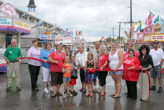 To open the Ionia Free Fair, the Ionia Area Chamber of Commerce Ambassadors, and the Ionia Free Fair Association members gathered at the midway Thursday to honor the Ionia Free Fair as being the largest fair in Michigan.