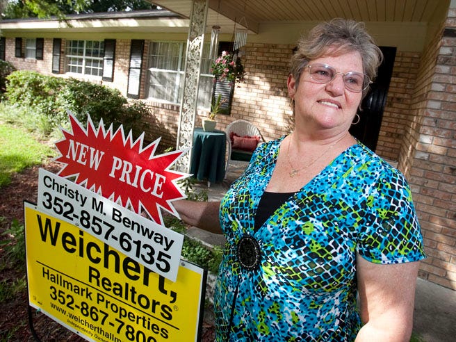 Jewel Estep stands outside her Ocala home that is for sale Wednesday afternoon. A scammer recently listed Estep's home for rent, trying to get a $750 deposit and first month's rent from potential renters. The scammer also listed pictures of the house they took off an MLS listing.