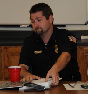 Holly Springs fire commissioners had a specially called meeting at 2:45 p.m. Friday, where they fired Fire Chief Lee Jeffcoat. Above, Jeffcoat leaves the table after being fired.