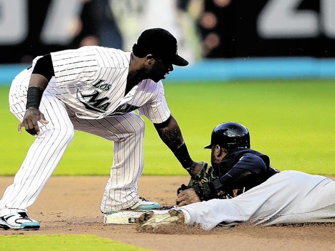 Florida Marlins shortstop Hanley Ramirez, left, tags out Atlanta Braves' Jason Heyward who tried to steal second base in the first inning of a baseball game in Miami, Friday, July 23, 2010.