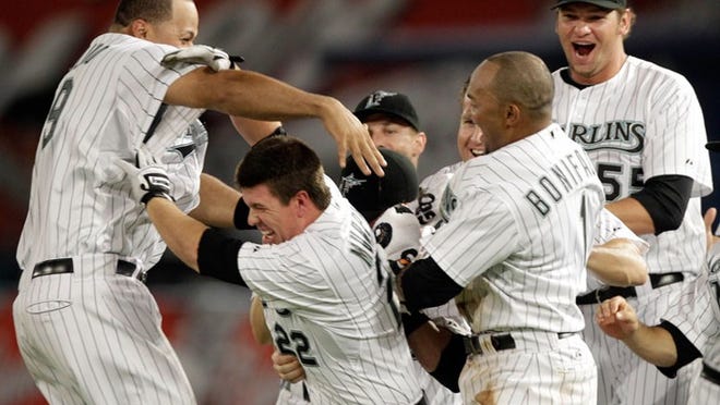 Donnie Murphy (center) is the life of the party after his two-out RBI single lifts the Marlins to a win over the Braves.