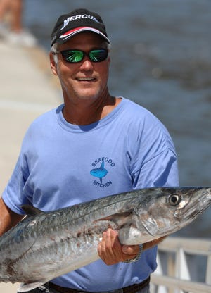Day 1 leader Russell Stuart smiles as he brings in a 27.75-pound kingfish Friday during the second day weigh-in for the 30th annual Greater Jacksonville Kingfish Tournament and Festival Friday. By RICK WILSON, Morris News Service