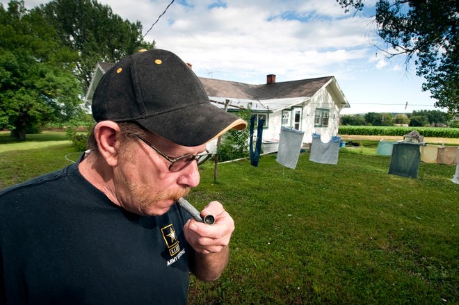David Fox, a veteran who uses medical marijuana to deal with the pain from 
neuropathy, smokes outside his home in Pompey's Pillar, Mont.NEW YORK TIMES 
/ TONY DEMIN