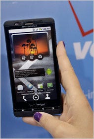A Best Buy customer in Mountain View, Calif., looks at a Motorola Droid phone by Verizon.