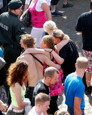 People seek first aid Saturday after a stampede in a tunnel at the Love 
Parade techno-music festival in Duisburg, Germany.AP PHOTO / HERMANN J. 
KNIPPERTZ