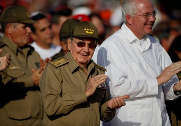 Cuba's President Raul Castro, front left, and Venezuela's Vice President Rafael Ramirez applaud during a rally marking the Cuba's Revolution Day in Santa Clara, Cuba, on Monday.