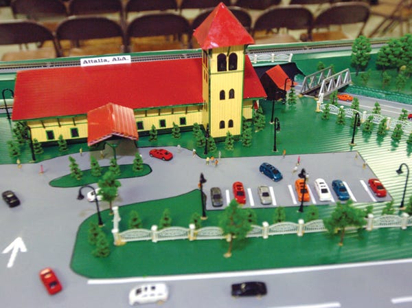 A model of the proposed visitor's center “The Junction,” seen above Thursday at the Elliott Community Center in Gadsden, shows what the building and grounds could look like at the Five Points intersection in Attalla.