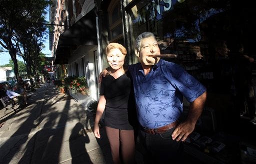 Rhinebeck residents Gary Kiernan, right, and Laurie Bathrick wear Bill and Hillary Clinton masks while walking in downtown Rhinebeck, Thursday, July 29, 2010 in Rhinebeck, N.Y. The real former President Bill Clinton was seen walking along the main street of the town Friday afternoon.