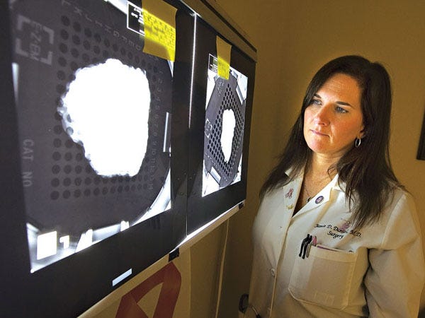 Dr. Jamie Daniel of Central Florida Breast Clinic poses with X-rays of tumors in her Ocala office on Monday, July 12, 2010.