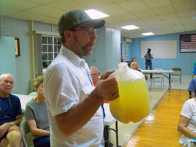 Craig Sautner brought a plastic jug of cloudy yellow water from his house near Dimock to the forum at Dingmans Ferry.   To purchase a reprint of this photo, go to  www.PoconoRecord.com/photostore.