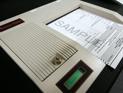 A demo unit and sample ballot shows what voters can expect elections to look like this year in the switch to an optical scan voting system. The ballot is filled out by bubbling in a choice and then, using a privacy shield, inserted into the optical scan machine. The machine is programmed to detect possible errors one might make in voting, such as bubbling in multiple choices in an area that only asks for one.