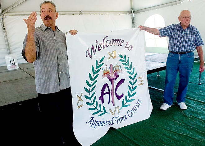 JAMES QUIGG, DAILY PRESS Steve Aguilar, left, and his father Raul Aguilar show off the banner they will using during the old time tent revival they are planning for Friday, Saturday and Sunday.
