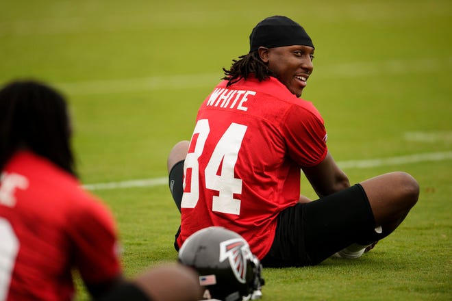 Atlanta Falcons receiver Roddy White (84) stretches during the morning session of NFL football training camp in Flowery Branch, Ga., Saturday, July 31, 2010. (AP Photo/Paul Abell)