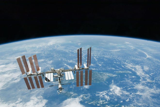 This Feb. 19. 2010 file photo provided by NASA shows the International Space Station with Earth's horizon as a backdrop. Several power systems have been shut down aboard the International Space Station after a cooling system malfunctioned. NASA says in a posting on its website that one of two cooling loops aboard the space station was shut down Saturday, July 31, 2010. A module that pumps ammonia coolant to prevent equipment from overheating was still shut down early Sunday, Aug. 1.