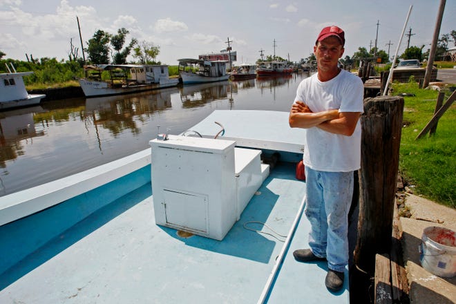 Capt. Rusty Graybill, a shrimp, crab and oyster fisherman poses on his boat in Yscloskey, La., Friday, July 30, 2010. About 70 percent of Louisiana waters are now open to some kind of commercial fishing, but state waters in Mississippi and Alabama remain closed and so do nearly a quarter of federal waters in the Gulf. Seafood industry representatives hailed the reopening, but Rusty Graybill, a boat captain from Yscloskey, La., who fishes for crab, oysters and shrimp, said "it's a joke."
