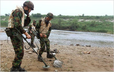South Korean Army soldiers searched for land mines washed up from the North in Yeoncheon, north of Seoul, on Sunday.