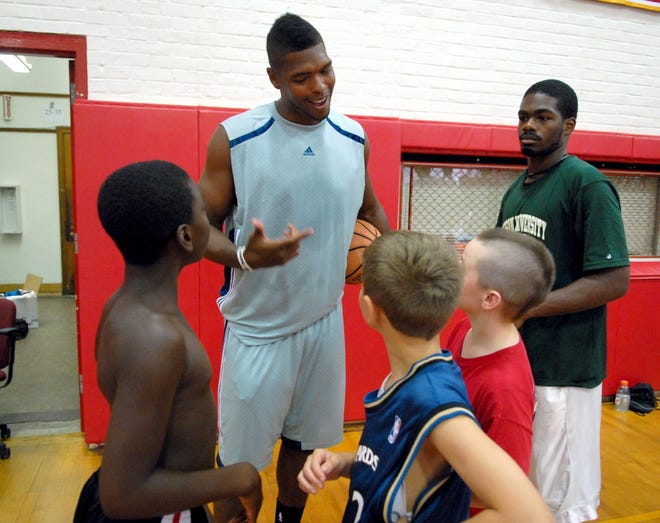 L.A. Clippers Ryan Gomes talks with basketball camp kids at the Mark Jones basketball at NFA.