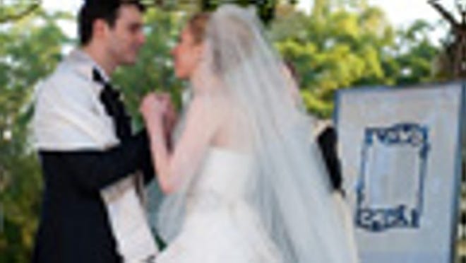In this photo provided by Genevieve de Manio Photography, Chelsea Clinton and Marc Mezvinsky are seen during their wedding, Saturday, July 31, 2010 in Rhinebeck, N.Y. Chelsea Clinton wed her longtime boyfriend under extraordinary security at an elegant Hudson River estate late Saturday. (AP Photo/Genevieve de Manio ) NO SALES