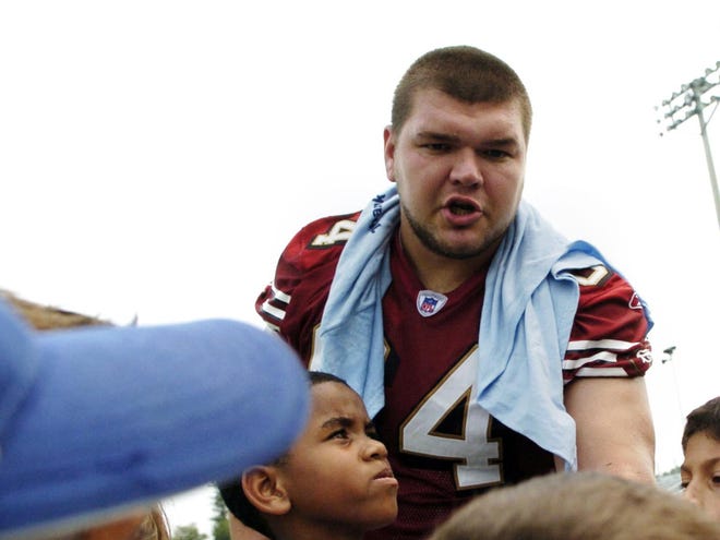 David Baas, a Riverview High School graduate and offensive lineman with the San Francisco 49ers, shown here working at a children's camp in Sarasota, suffered a mild concussion Monday during practice at the San Francisco 49ers camp.