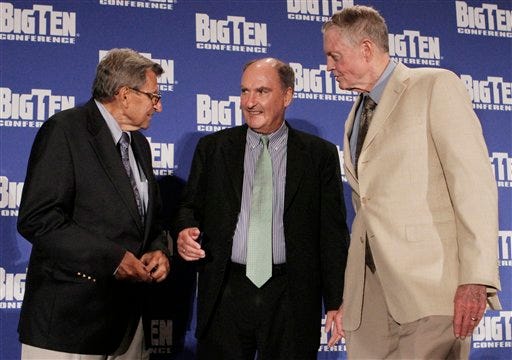 Penn State coach Joe Paterno, left, and Nebraska athletic director Tom Osborne, right, join Big Ten commissioner Jim Delany on stage Monday, Aug. 2, 2010, in Chicago, at the Big 10 football media day. Nebraska joins the Big Ten next season, bringing the conference to 12 teams. (AP Photo/M. Spencer Green)