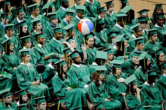 A graduate launches a beach ball during Rock Bridge High School’s commencement ceremony at Mizzou Arena. 560 Rock Bridge seniors earned diplomas this year.