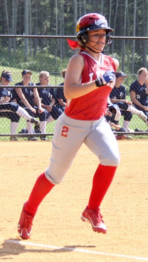 Maria Battista makes her way to first base Friday.