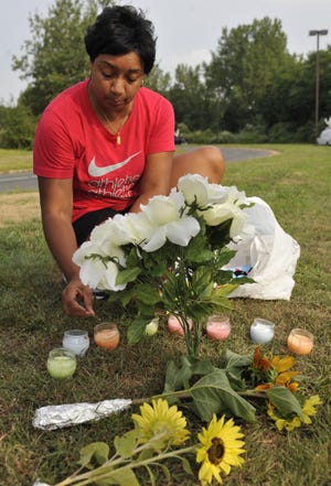 Terrie Thomas of South Windsor lights candles Wednesday outside the Hartford 
Distributors in Manchester, Conn., in memory of the victims of the shootings 
Tuesday at the warehouse.ASSOCIATED PRESS / JESSICA HILL