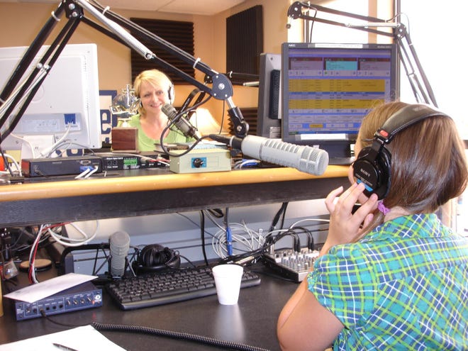 WSMR LIFE 89.1 radio personality Laura Chase, left, talks on the air with listener Jessica Bynum, 11, in the studio Wednesday.