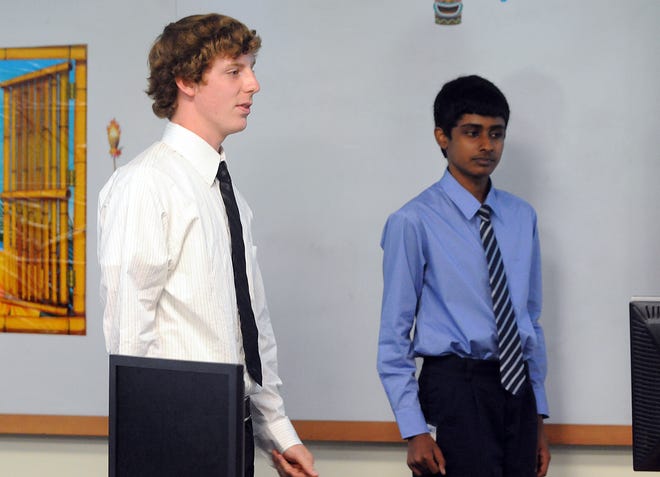 Ben Callahan, left, explains his group's business plan, for EMC product LifeLine during the STAR mock business course at EMC in Milford, Thursday. Also in the group is Vishant Prabhakaran.