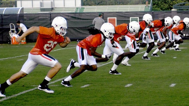 Players run drills at the University of Miami's first practice of the 2010 season. UM reported potential recruiting violations to the NCAA by coaches who may have broken text-messaging rules.