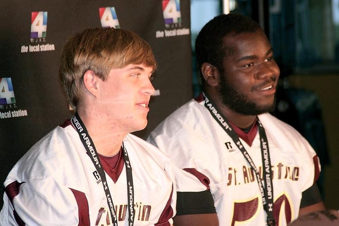 St. Augustine football players Kyle West, left, and Tarek Odom talk during Thursday's High School Awareness Day at EverBank Field. By JUSTIN BARNEY