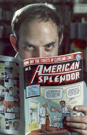 Comic-book writer Harvey Pekar poses with a copy of his "American Splendor" in his Cleveland Heights home. Pekar, whose comic was made into a 2003 film starring Paul Giammati, was been found dead early Monday.