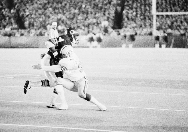 In a photo from a Monday Night Football Game on Oct. 22, 1985, Green Bay Packers’ Mark Murphy, a GlenOak graduate, wraps his arm around future Pro Football Hall of Famer Walter Payton to tackle, short of inches, before a first down in the fourth quarter. Payton still gained 112 yards on 25 carries in the game.
