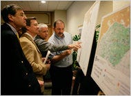 Bidders look over plot maps in New Orleans in 2006 before the Minerals Management Service sale for blocks of offshore oil and natural gas production in the Gulf of Mexico.