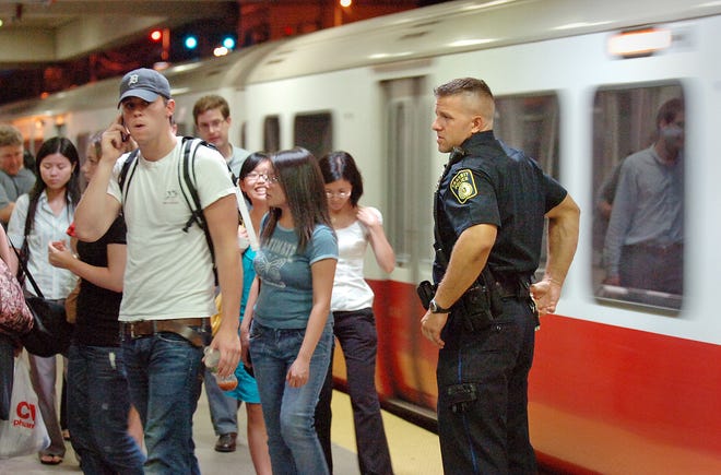 Transit Police Officer Andrew Galonzka patrols the platform at the Wollaston MBTA station on Wednesday, Aug. 4, 2010 in Quincy.