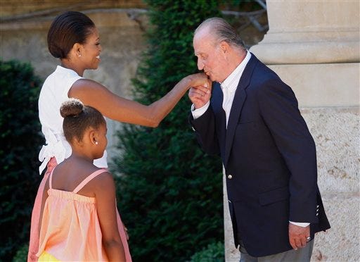 Spain's King Juan Carlos, right, welcomes U.S. first lady Michelle Obama and daughter Sasha, 9, on their arrival at the Marivent Palace, in Palma de Mallorca, Spain, Sunday, Aug. 8, 2010. The White House says first lady Michelle Obama is in Spain for a private trip with longtime family friends. (AP Photo/Manu Mielniezuk)