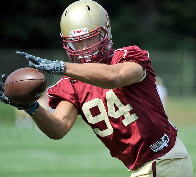 Though held out of practice yesterday - Boston College's first of the fall camp as the team readies for the 2010 season - linebacker Mark Herzlich works on his hands by catching balls from a passing machine.
