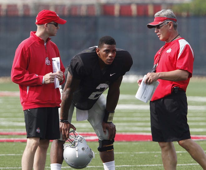 Ohio State head coach Jim Tressel, right, and quarterbacks coach Nick Siciliano, left, talks to quarterback Terrelle Pryor (2) during an NCAA college football practice Tuesday in Columbus.