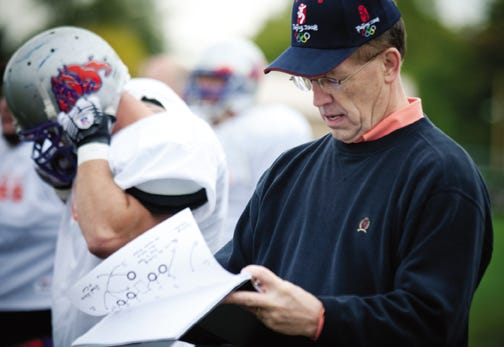 Pontiac Mayor Bob Russell looks over the playbook at last year’s “One More Game” at Williamson Field. Russell coached his team to a victory and will be back on the sideline for this year’s game on Sept. 4.