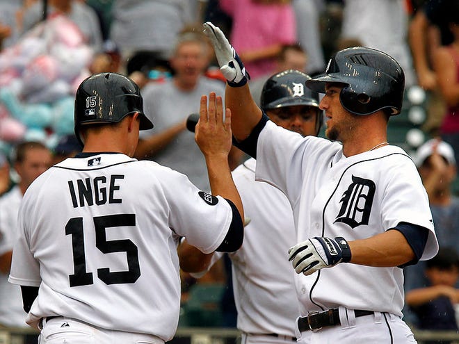 Detroit Tigers' Ryan Raburn, right, is congratulated by Brandon Inge after his two-run home run in the sixth inning of a baseball game against the Tampa Bay Rays in Detroit, Wednesday, Aug. 11, 2010. (AP Photo/Carlos Osorio)