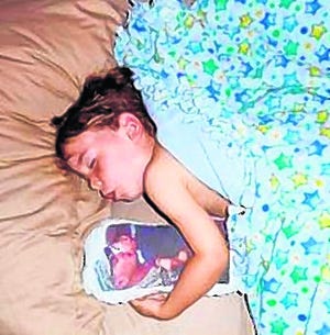 Hayden Cleve sleeps with the pillow Sandra Stafford made for him. It has replaced Bunny, the rabbit he sent to Justin Stafford in Iraq. Sandra Stafford wants to make pillows for other military families and send them overseas, free of charge.