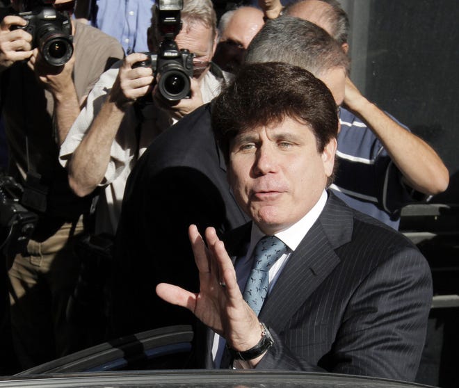 Former Gov. Rod Blagojevich waves as he gets into a car after appearing in court Wednesday. M. Spencer Green/The Associated Press