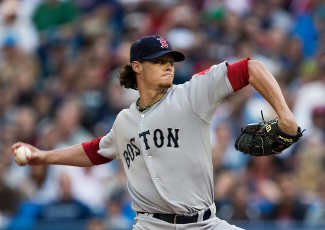 Boston Red Sox starting pitcher Clay Buchholz throws a pitch against the Toronto Blue Jays during first inning f their baseball game in Toronto on Wednesday, Aug. 11, 2010. (AP Photo/The Canadian Press, Nathan Denette)