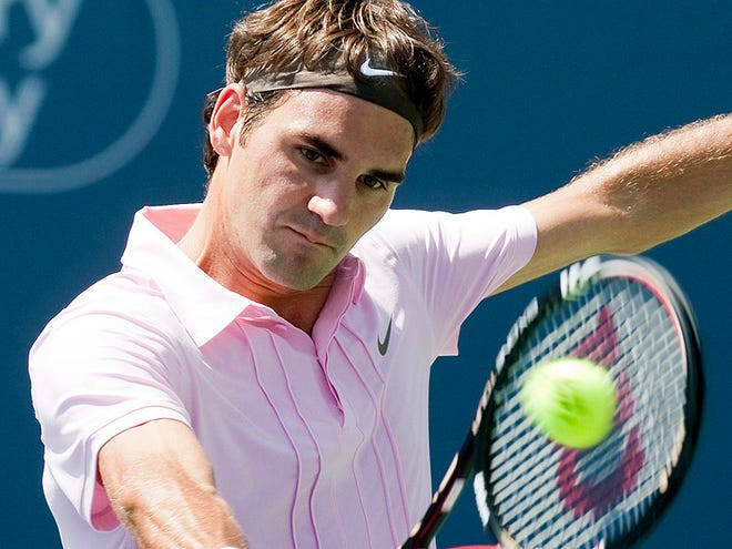 Roger Federer of Switzerland makes a return to Michael Llodra of France at the Rogers Cup tennis tournament in Toronto, Thursday, Aug. 12, 2010. (AP Photo/The Canadian Press, Frank Gunn)