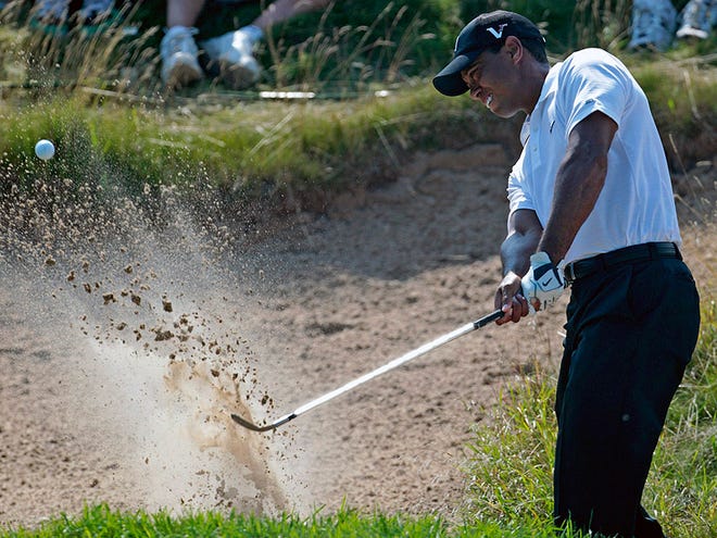 Tiger Woods hits out of a bunker on the second hole during the first round of the PGA Championship golf tournament Thursday, Aug. 12, 2010, at Whistling Straits in Haven, Wis. (AP Photo/Charlie Riedel)