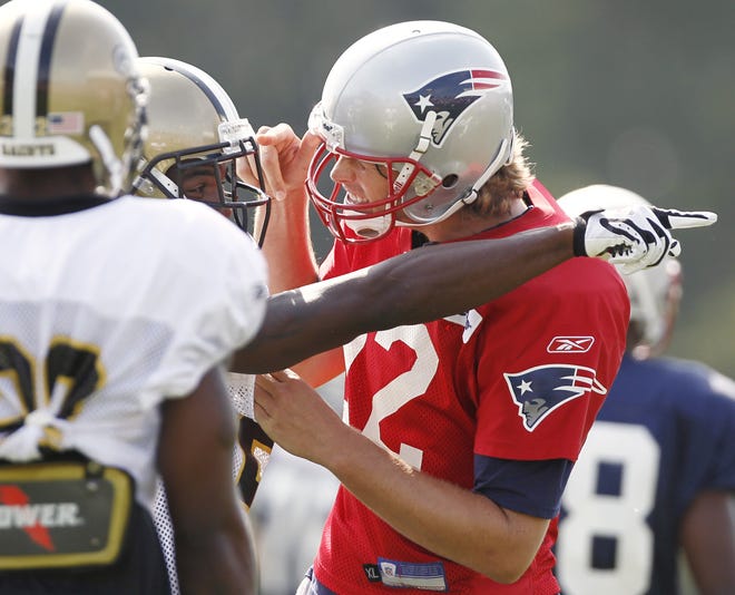Patriots quarterback Tom Brady, jokingly gets in the face of Saints cornerback Randall Gay on Wednesday after throwing a touchdown pass during a joint practice in Foxboro, Mass. Their teams meet in a preseason game tonight.