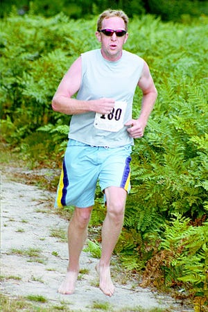 Pat Howard runs the dirt course during Polishfest in Boyne Falls on Aug. 7. Next up is completing the 62-mile North Central Trail on Saturday.