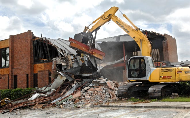 An American Clearing & Hauling excavator takes a bite out of the old Carver State Bank building. (Photo by Carl Elmore/Savannah Morning News)