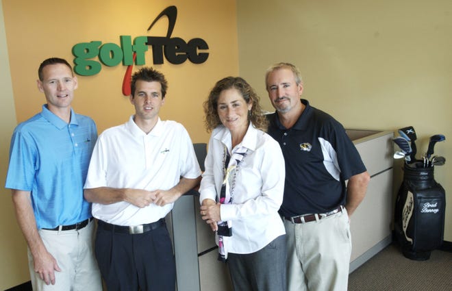 Brady Benney, Nick Germann, Yvette Gonzales and Chip McCann pose at GolfTEC Columbia. Benny and Germann are coaches at the business, which is owned by Gonzales and McCann.